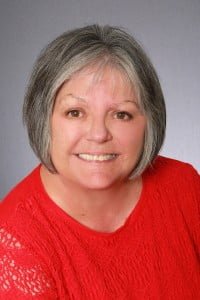 Mary wearing red smiling for headshot