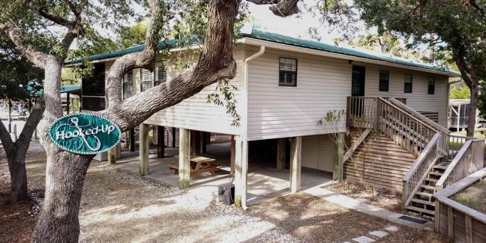 canal front home with covered boat dock located in the Gulf Beaches